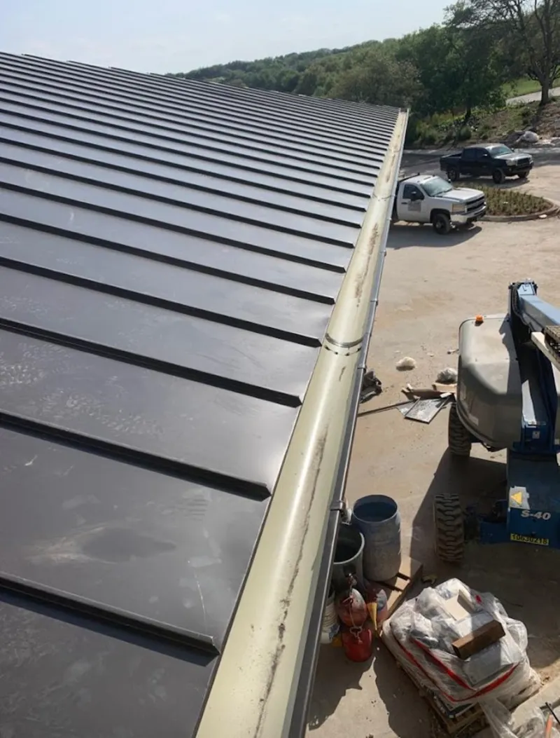 Standing seam panel and gutter detail on a metal roofing jobsite in Steubenville